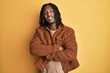 © Krakenimages.com - African american man with braids wearing brown retro jacket happy face smiling with crossed arms looking at the camera. positive person.