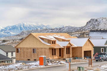 Wall Mural - House under construction in Utah Valley against snowy mountain and cloudy sky