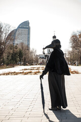 Wall Mural - plague doctor in an empty city on the background of the temple