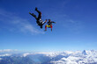 © Talent for Adventure - Skydivers perform tricks above snowcapped mountains