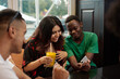 © etonastenka - Young latin woman laughs while looking at her friend's phone