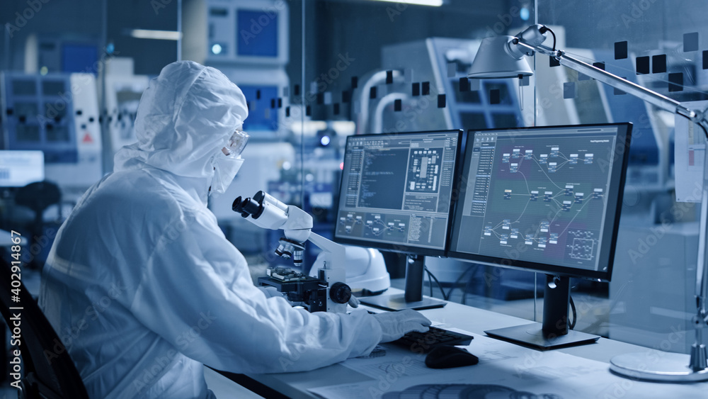 Electronics Factory Cleanroom: Engineer / Scientist in Coveralls Works ...