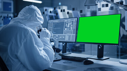 Aufkleber - Research Factory Cleanroom: Close-up of Engineer / Scientist wearing Coverall and Gloves Uses Microscope, Computer Has Chroma Key Green Screen Display. Scientific and Electronics Research Facility