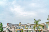 Fototapeta Londyn - Resort like neighborhood in Long Beach California with homes against cloudy sky