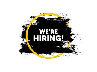 We're hiring symbol. Paint brush stroke in circle frame. Recruitment agency sign. Hire employees symbol. Paint brush ink splash banner. Hiring badge shape. Grunge black watercolor banner. Vector