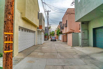 Wall Mural - Car on a narrow neighborhood street along houses in Long Beach California