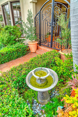 Wall Mural - House facade with fountain on the yard and wrought iron gate in Long Beach CA