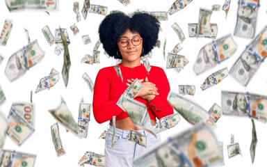 Sticker - Young african american girl wearing casual clothes and glasses smiling with hands on chest with closed eyes and grateful gesture on face. health concept.