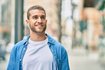 Sticker - Young caucasian man smiling happy standing at the city.