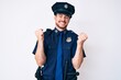 © Krakenimages.com - Young caucasian man wearing police uniform very happy and excited doing winner gesture with arms raised, smiling and screaming for success. celebration concept.
