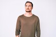 © Krakenimages.com - Young handsome man wearing casual clothes smiling looking to the side and staring away thinking.