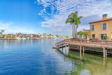 Houses And Docks Bordering The Sea Under Cloudy Blue Sky In Huntington Beach