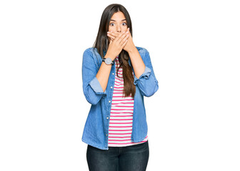 Poster - Young brunette woman wearing casual clothes shocked covering mouth with hands for mistake. secret concept.