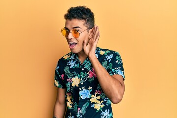 Wall Mural - Young handsome african american man wearing summer style smiling with hand over ear listening and hearing to rumor or gossip. deafness concept.