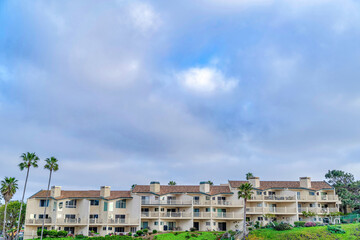 Canvas Print - Residential houses with clouds and blue sky background in San Diego California