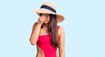 Sticker - Young beautiful latin girl wearing swimwear and summer hat tired rubbing nose and eyes feeling fatigue and headache. stress and frustration concept.