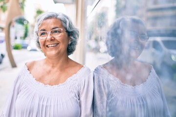 Poster - Middle age woman with grey hair smiling happy outdoors