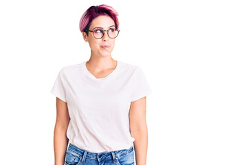 Sticker - Young beautiful woman with pink hair wearing casual clothes and glasses smiling looking to the side and staring away thinking.