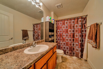 Wall Mural - White sink on marble countertop with wood cabinet beside toilet of bathroom