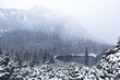 Snowing winter landscape with the lake from far in Tatra mountains