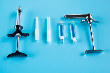 Wall Mural - Dentistry medical tools syring on blue background.