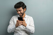 © IndiaPix - A YOUNG EXECUTIVE LAUGHING WHILE USING MOBILE PHONE DURING VIDEO CONFERENCING