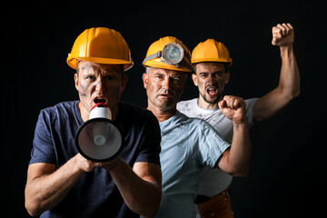 Wall Mural - Protesting miner men with megaphone on dark background