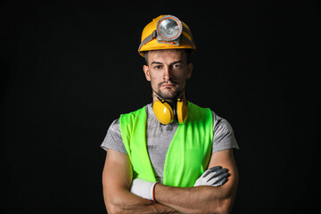 Wall Mural - Miner man on dark background