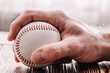 © andrey gonchar - Male hand grabbing a baseball - pitcher technique in play