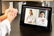 © golubovy - Video chat. Online partnership. Virtual meeting. International cooperation. Diverse multiracial colleagues greeting on tablet screen in modern home office.
