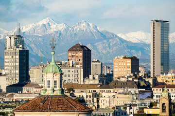 Milan skyline with the background of the snowcapped Grigne mountains