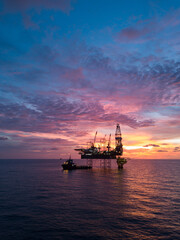 Wall Mural - Aerial view offshore drilling rig (jack up rig) at the offshore location during sunset