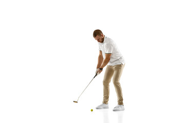 Wall Mural - Passioned. Golf player in a white shirt taking a swing isolated on white studio background with copyspace. Professional player practicing with bright emotions and facial expression. Sport concept.