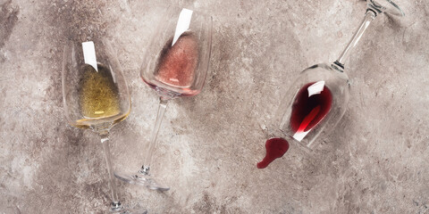 Wall Mural - Flat lay white, rose and red wine in glass on beige rustic background, banner. Collection of various wines. Top view.