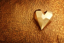 Top View Of Gold Heart Over Bronze Background