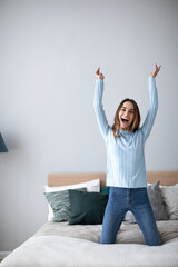 Wall Mural - Happy young woman on bed at home.