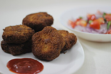 Wall Mural - Star shaped chicken cutlets served with onion tomato salad made as Christmas season snack