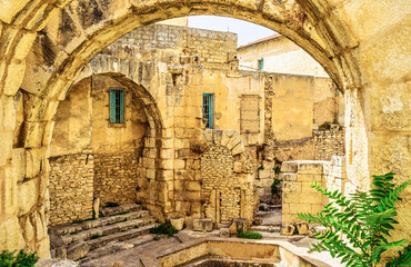 Wall Mural - The view through the arch in the antique archaeological site, El Kef, Tunisia