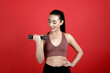 © New Africa - Woman with dumbbell as girl power symbol on red background. 8 March concept