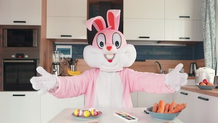 Wall Mural - Easter Bunny or rabbit preparing for celebrate Happy easter. Man in adult giant bunny costume painting eggs