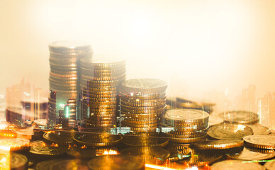 Wall Mural - row of coin stack with double exposure night city background for financial banking and saving money and business stock investment concept.