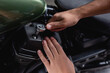 © LIGHTFIELD STUDIOS - cropped view of mechanic using socket wrench while making diagnostics of motorcycle in workshop