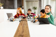 © BGStock72 - Happy kids programming electric toys and robots at robotics classroom