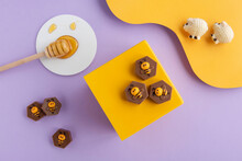 Special Honey-filled Chocolates Designed On A Purple And Yellow Platform