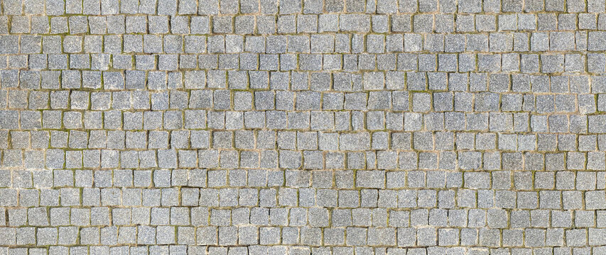 granite cobblestoned pavement background. stone pavement texture. abstract background of cobblestone