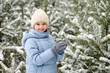 © Konstantin Koekin - Happy little girl with white teeth and a perfect smile in beautiful winter snow forest. Walking and active rest in winter