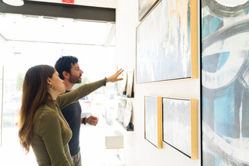 Side view of an attractive couple visiting an art gallery