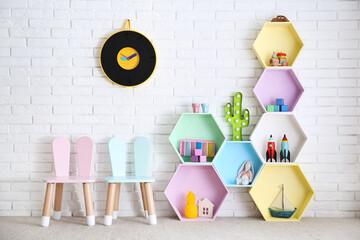 Poster - Child room interior with colorful shelves near brick wall