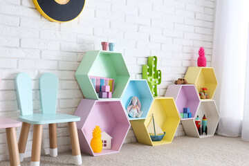 Poster - Child room interior with colorful shelves near brick wall