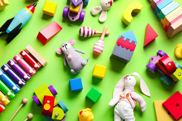 Wall Mural - Different toys on green background, flat lay